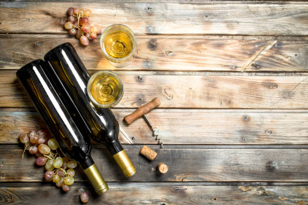 istock Wine background. White wine with branches of fresh grapes. 1141773198