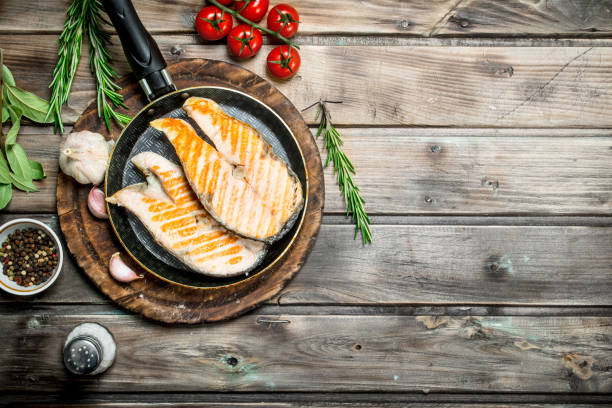 istock Grilled salmon in a pan with spices and herbs. 1141773490