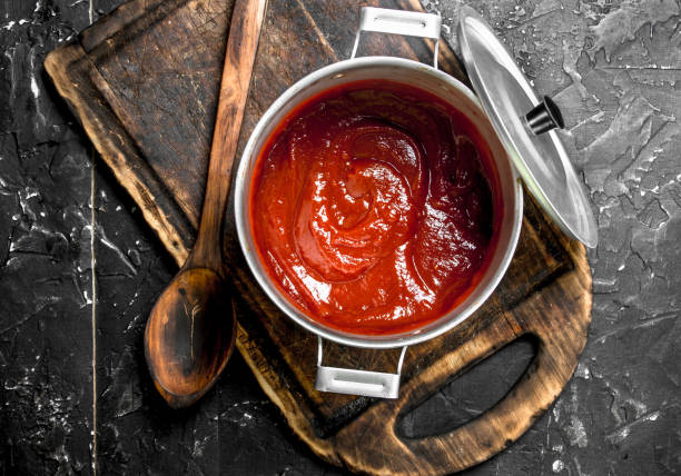 istock Tomato sauce in a pot on a cutting Board. 1141774991