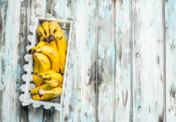 Fresh bananas in a white plastic basket.