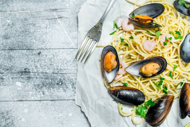istock Mediterranean pasta. Spaghetti seafood with clams on paper. 1141775050