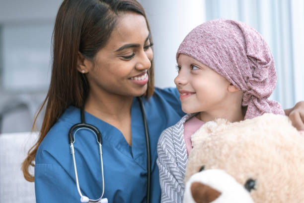 istock Kind doctor comforts girl with cancer 1141776211