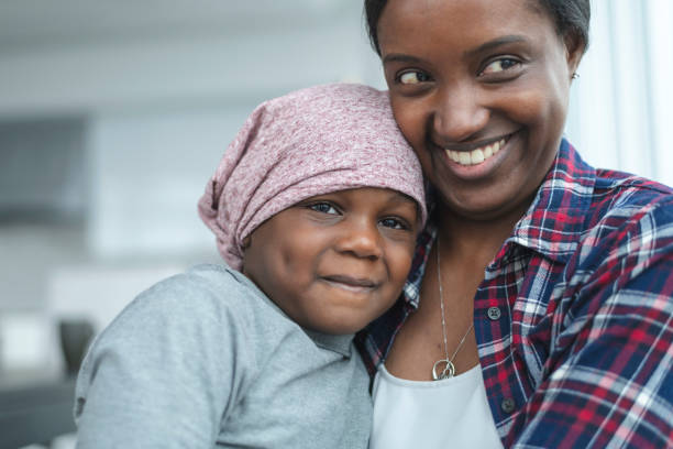 istock Supportive mother holds child with cancer 1141776214