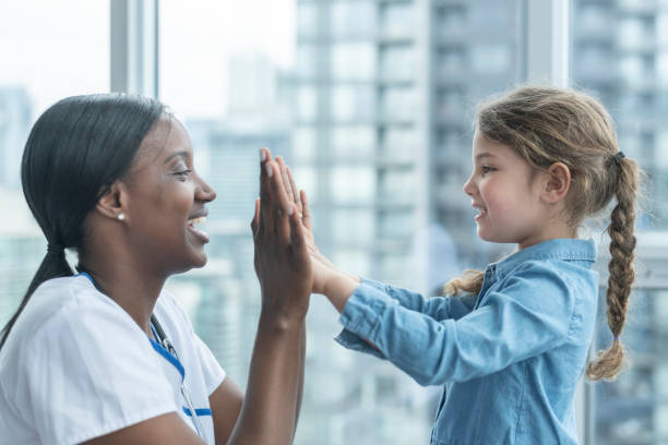 istock Child patient playing patty cake with doctor 1141776220