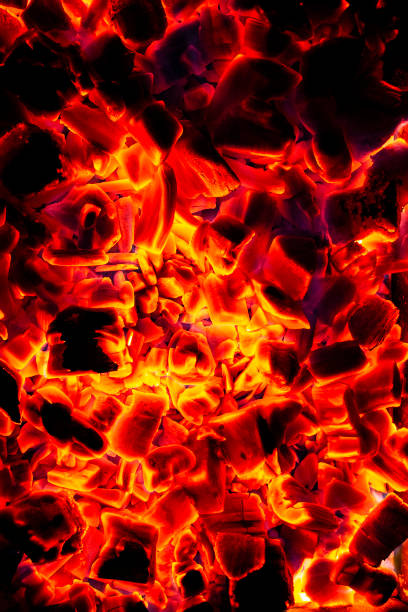 Glowing Hot Charcoal Briquettes Close-up Background Texture