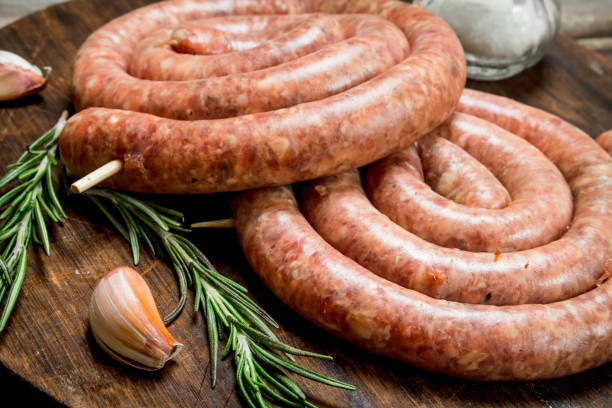 istock Raw sausage with rosemary and garlic. 1141776749