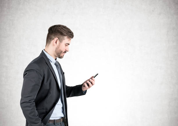 istock Businessman looking at smartphone, concrete 1141778520
