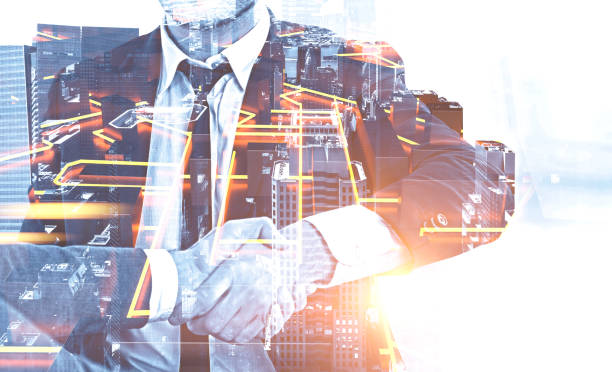 istock Businessmen shake hands, city plan 1141778580