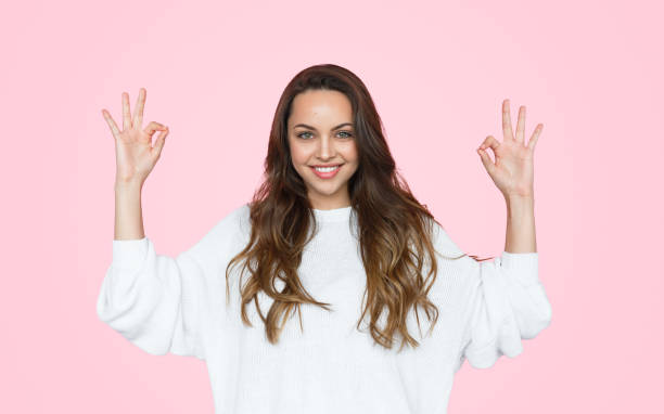 istock Young woman gesturing OK 1141779845