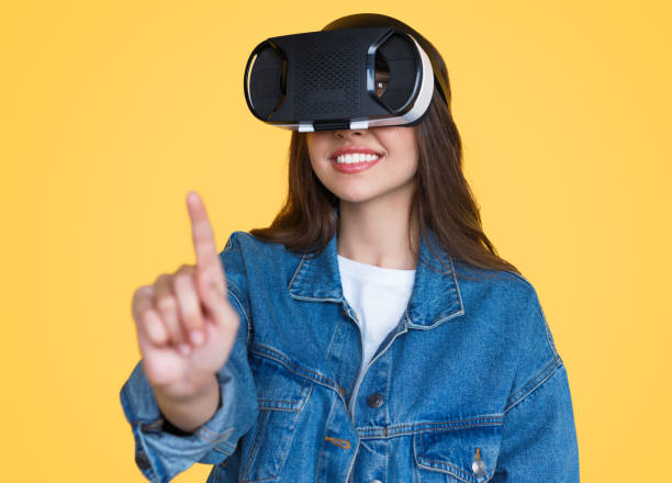 istock Modern woman in VR glasses touching air 1141779905