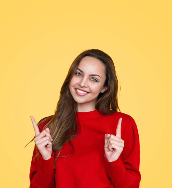 istock Charming woman pointing up 1141779915