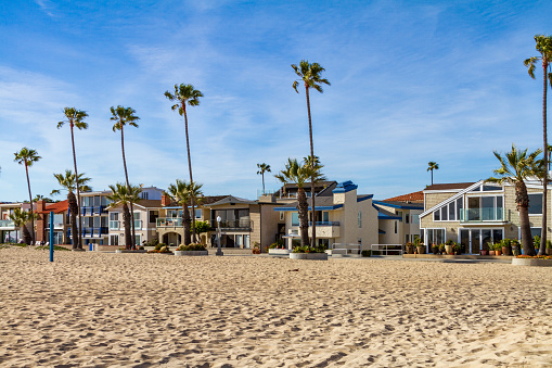 Newport Beach, CA / USA – April 6, 2019: Real Estate property along Ocean Front West in Newport Beach, California stand on the edge of the sand in the balboa peninsula area.