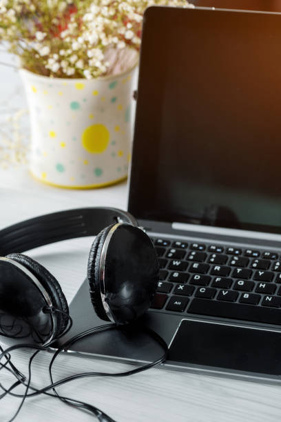 istock Headphones with laptop on a laptop computer keyboard 1141784124