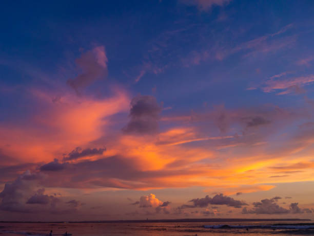 istock Surfers on the background of beautiful sunset clouds 1141785093