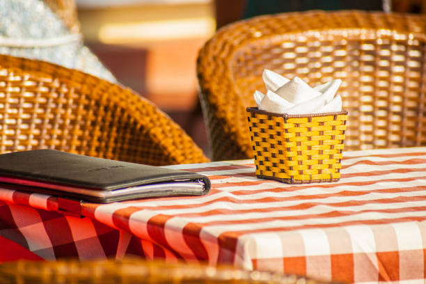 The cozy atmosphere of a small retro cafe with straw chairs and red tablecloth