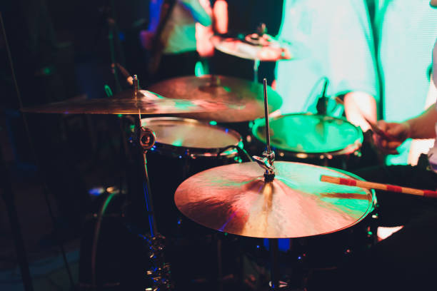 istock Drummer with a drumsticks in his hands playing on drum set on stage on the black background. 1141790083