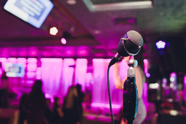 istock Retro microphone against blur colorful light in pub and restaurant background. 1141791940