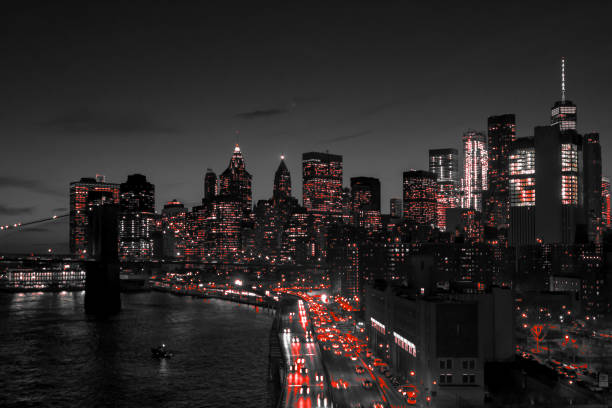 New York City black and white night skyline with red lights glowing in downtown Manhattan stock photo