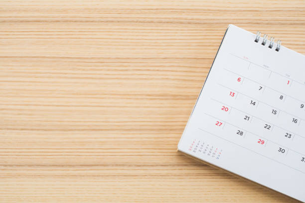 istock calendar page on wood table background 1141793712