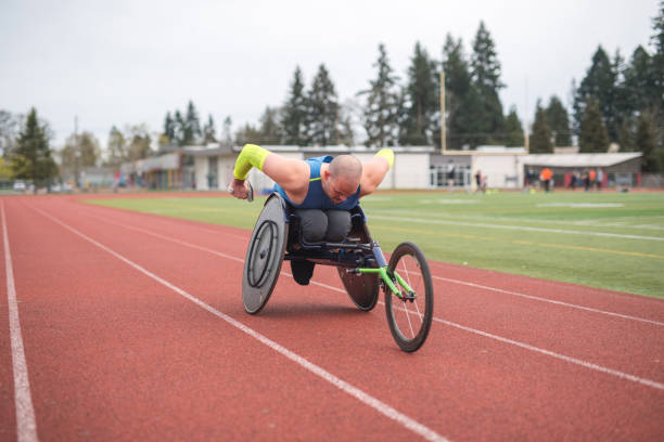 istock Adaptive athlete training on his racing wheelchair on a stadium track 1141795302