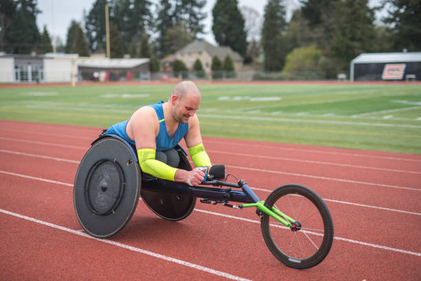istock Adaptive athlete training on his racing wheelchair on a stadium track 1141795303