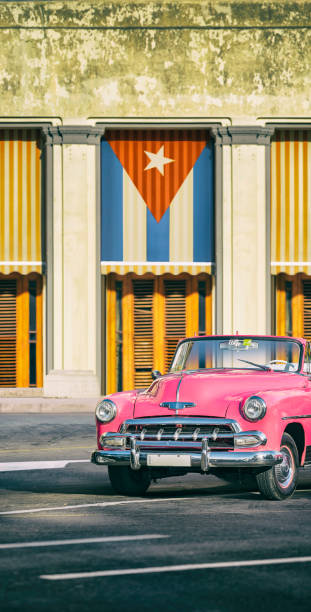 istock Vintage pink oldtimer car driving through Old Havana Cuba 1141796057