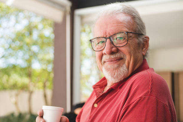 istock Senior drinking coffee at home 1141804362
