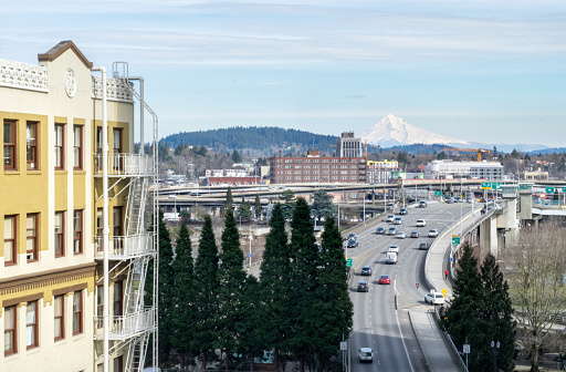 Aerial View of Historic Apartment/Office Building, Bridge, and Highway in Downtown Portland, with Mt. Hood in the Distance - Portland, Oregon, USA