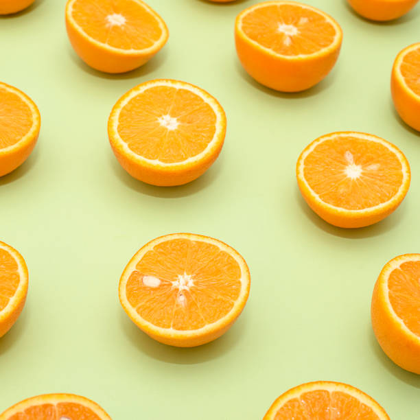 istock Orange juicy oranges split in half on green 1141811213