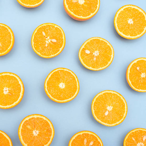 istock Orange juicy oranges split in half on blue 1141811739