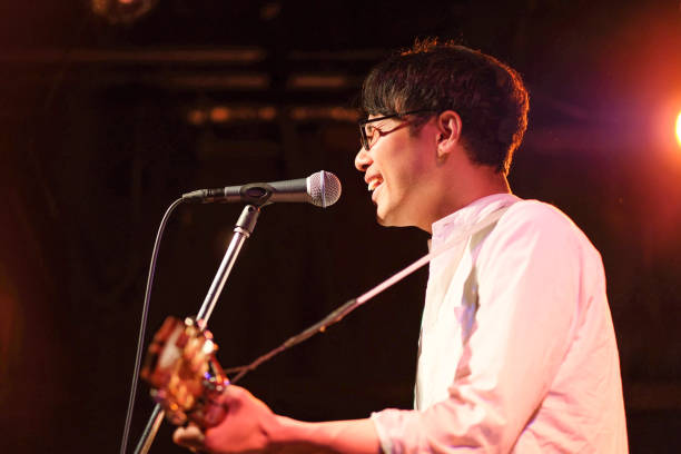 istock Singer singing songs on stage 1141815135