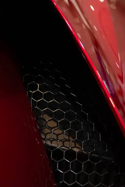Air intake on red luxury car. Close-up. Using wallpaper or background for transport and automotive image.