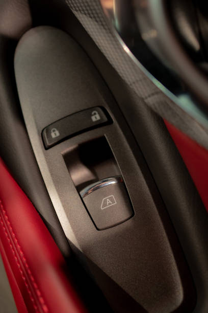 istock Window controlling button on the door console, black leather red lether, close-up. ar interior details. 1141815586