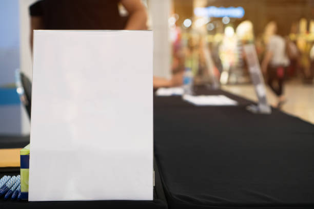 istock Stand White mockup acrylic frame tent card on counter reception in seminar check in for register, background layout insert space for text of information 1141817396