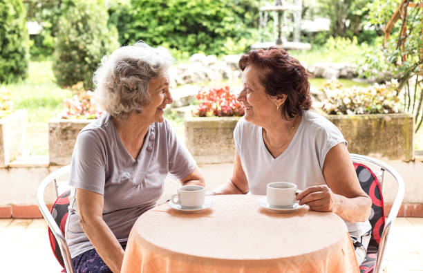 Senior women drinking coffee stock photo