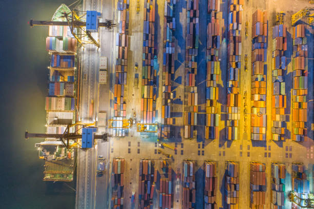 istock Logistics and transportation of Container Cargo ship and Cargo with working crane bridge in shipyard at sunrise, logistic import export and transport industry background 1141828011