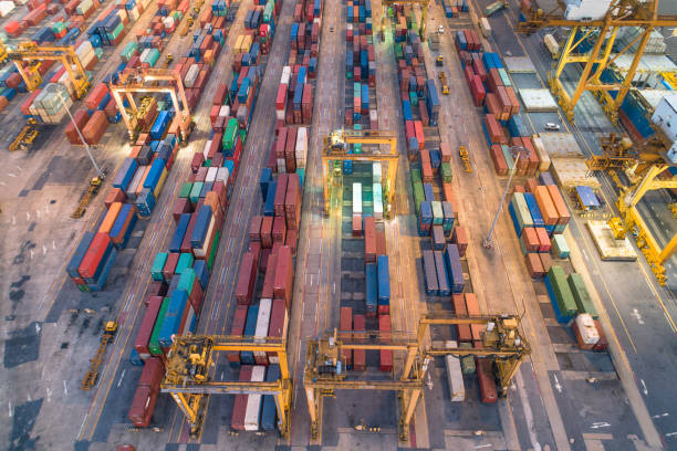 istock Logistics and transportation of Container Cargo ship and Cargo with working crane bridge in shipyard at sunrise, logistic import export and transport industry background 1141828014