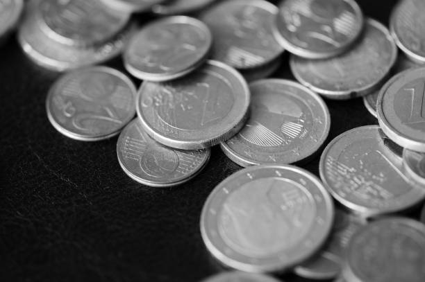 istock Euro coins scattered on a dark background close up. Black and white 1141830599