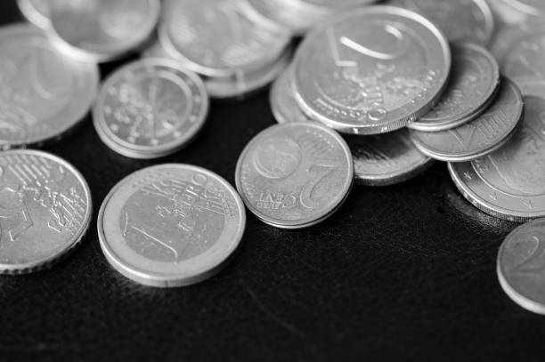 istock Euro coins scattered on a dark background close up. Black and white 1141830604