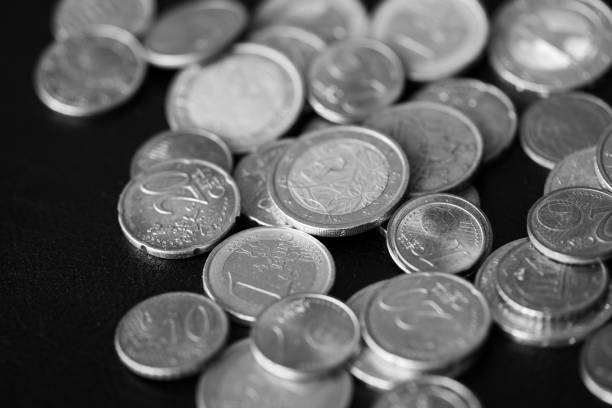 istock Euro coins scattered on a dark background close up. Black and white 1141830606