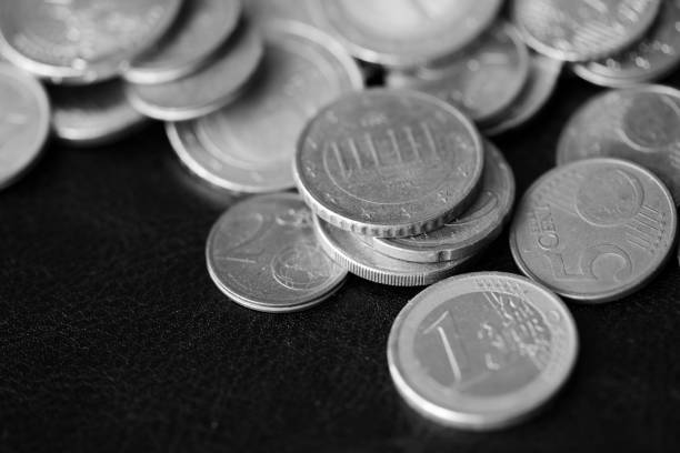 istock Euro coins scattered on a dark background close up. Black and white 1141830608