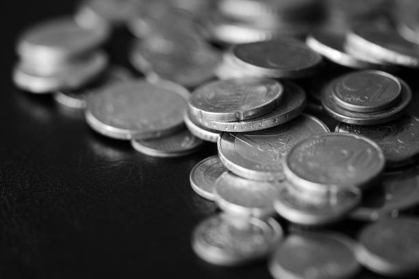 istock Euro coins scattered on a dark background close up. Black and white 1141830614