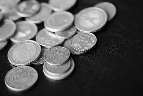 istock Euro coins scattered on a dark background close up. Black and white 1141830626