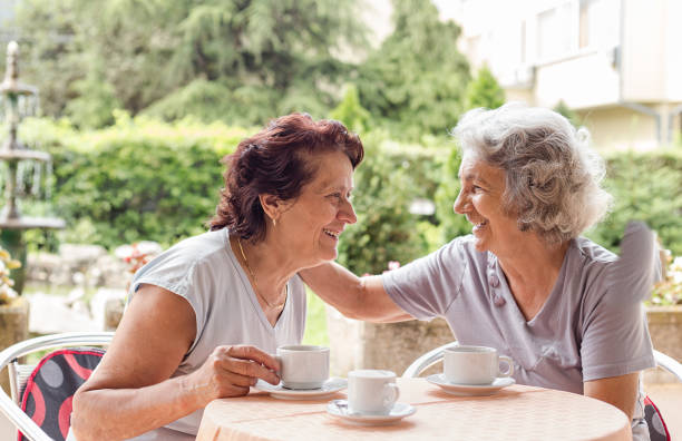 istock Senior women drinking coffee and laughing 1141831009