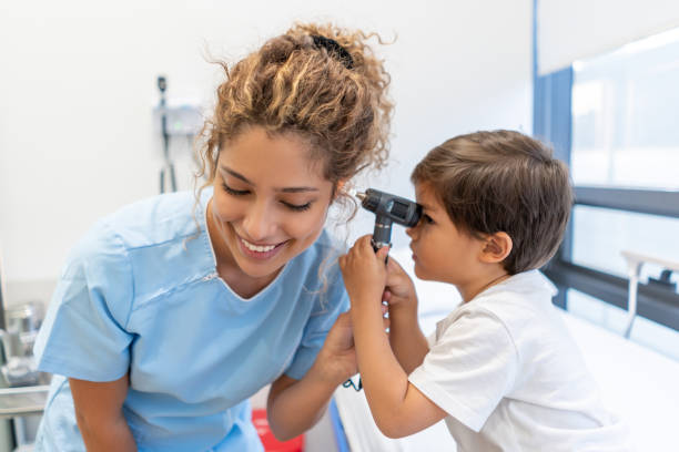 istock Sweet little patient checking nurse's ears very playfully 1141832711