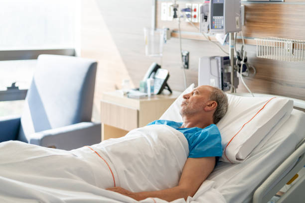 istock Alone senior man in hospital room lying down on bed looking away 1141832730