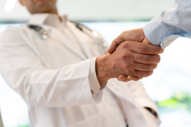 istock Unrecognizable doctor and hospital supervisor handshaking 1141832731