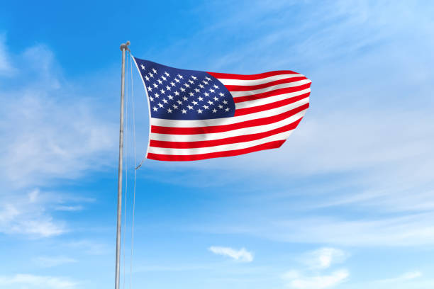 istock United States flag over blue sky background 1141834589