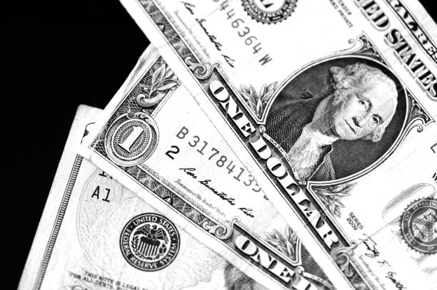 istock One and twenty dollar bills on a dark background close up in monochrome 1141840699