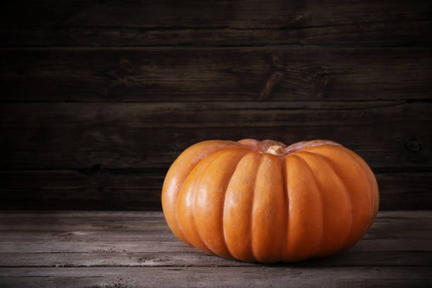 istock orange pumpkin on old wooden table 1141841806
